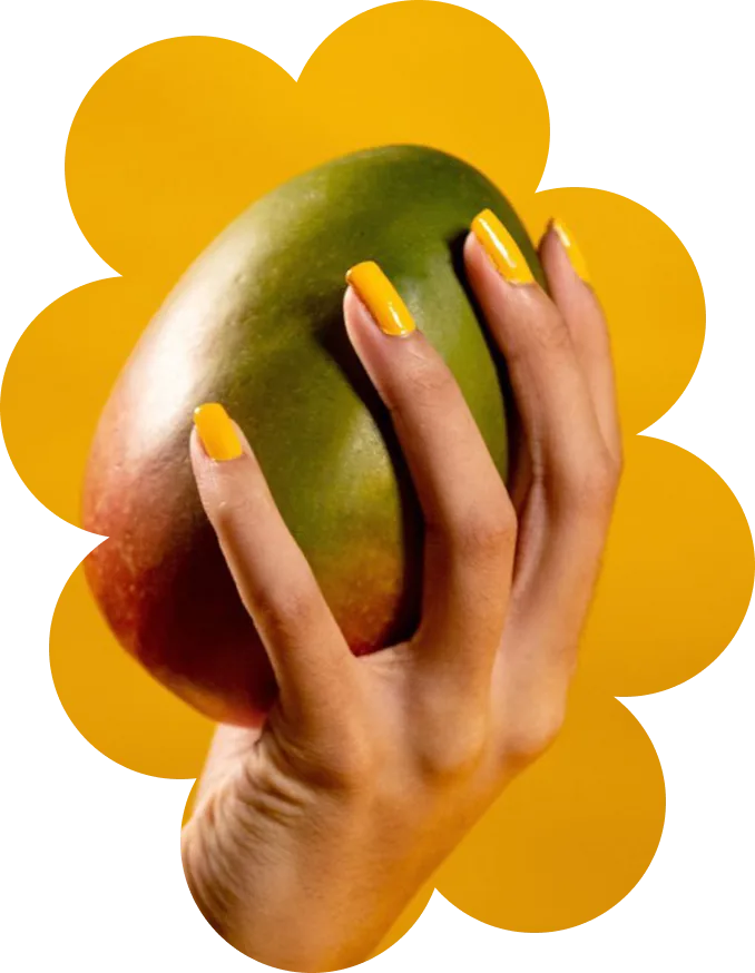A hand holding a fresh mango on a groovy flower